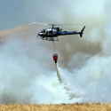 Helicopter dropping fire suppressant on a controlled burn in Rush Ranch.